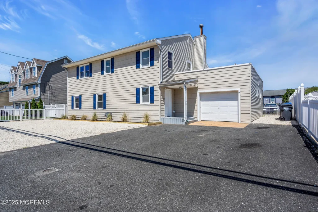 Exterior of a staged 7-bedroom coastal home in Toms River NJ’s Green Island area near the bay, featuring a spacious residential setting.